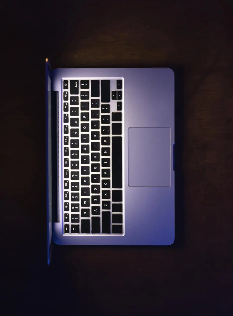 Top-down view of sleek laptop on dark desk